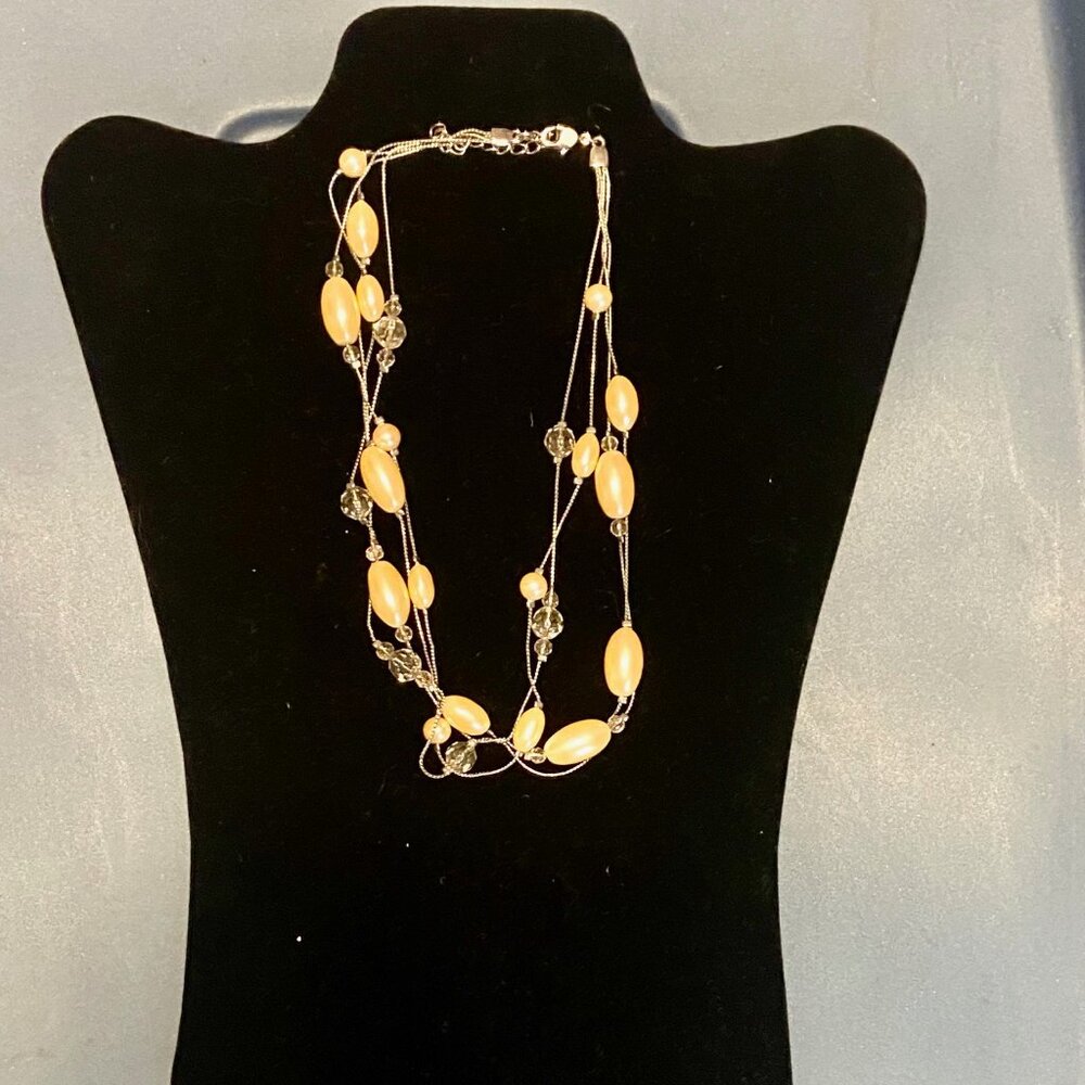 Faux pearl multi strand necklace on silver tone chain